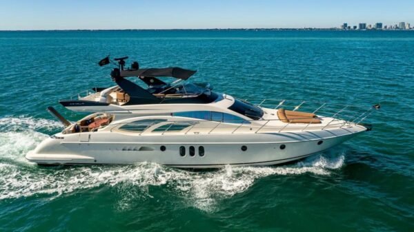 62' AZIMUT REGAL yacht sailing on the water, showcasing its elegant design and superior performance in a luxurious setting.