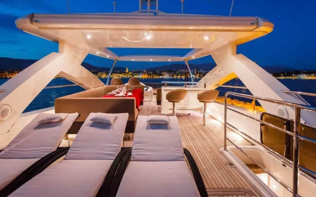 Luxurious upper deck lounge area of the yacht, offering panoramic ocean views.