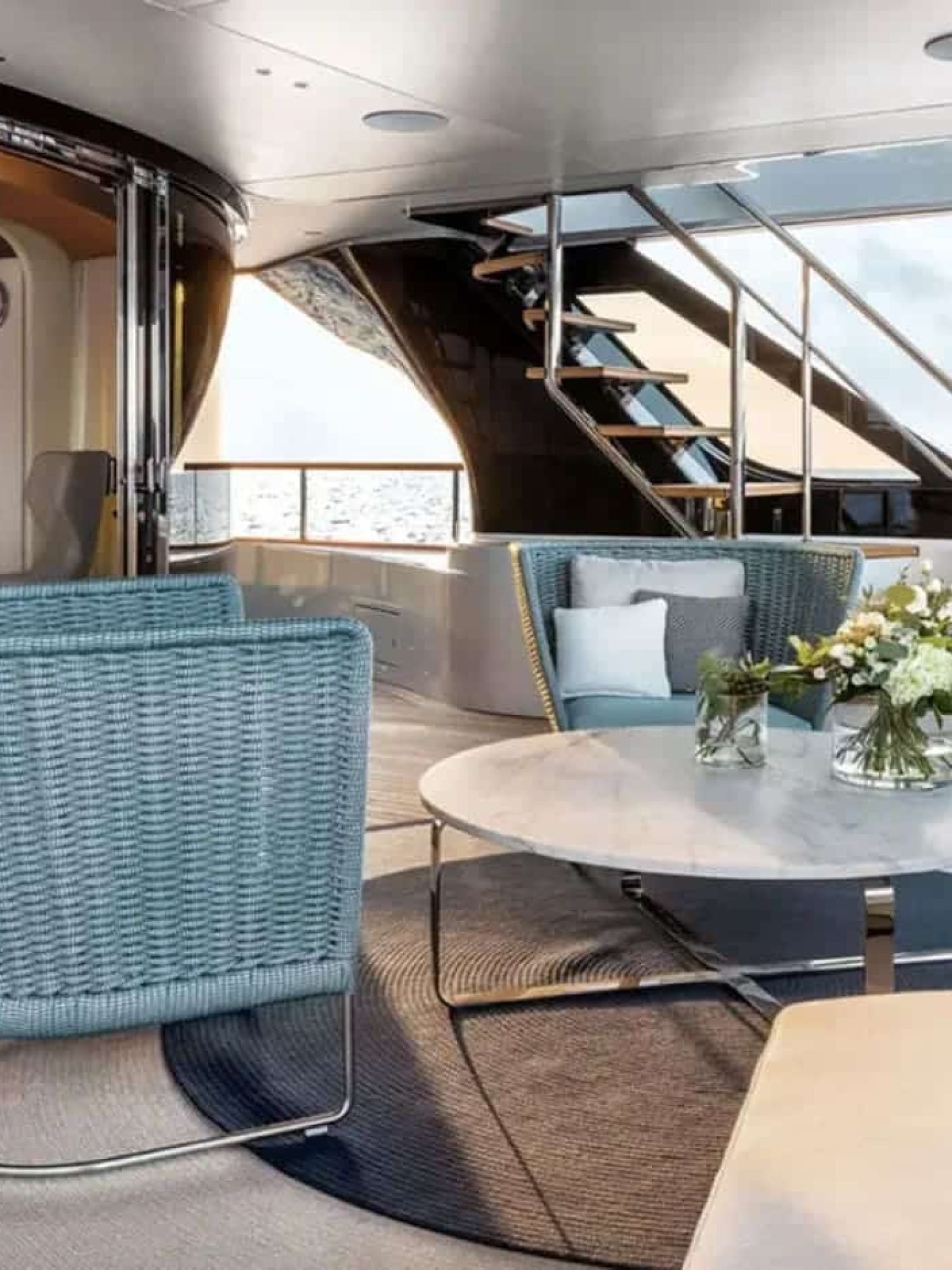 Elegant outdoor lounge space on the 125' Benetti yacht, ideal for enjoying the ocean breeze.