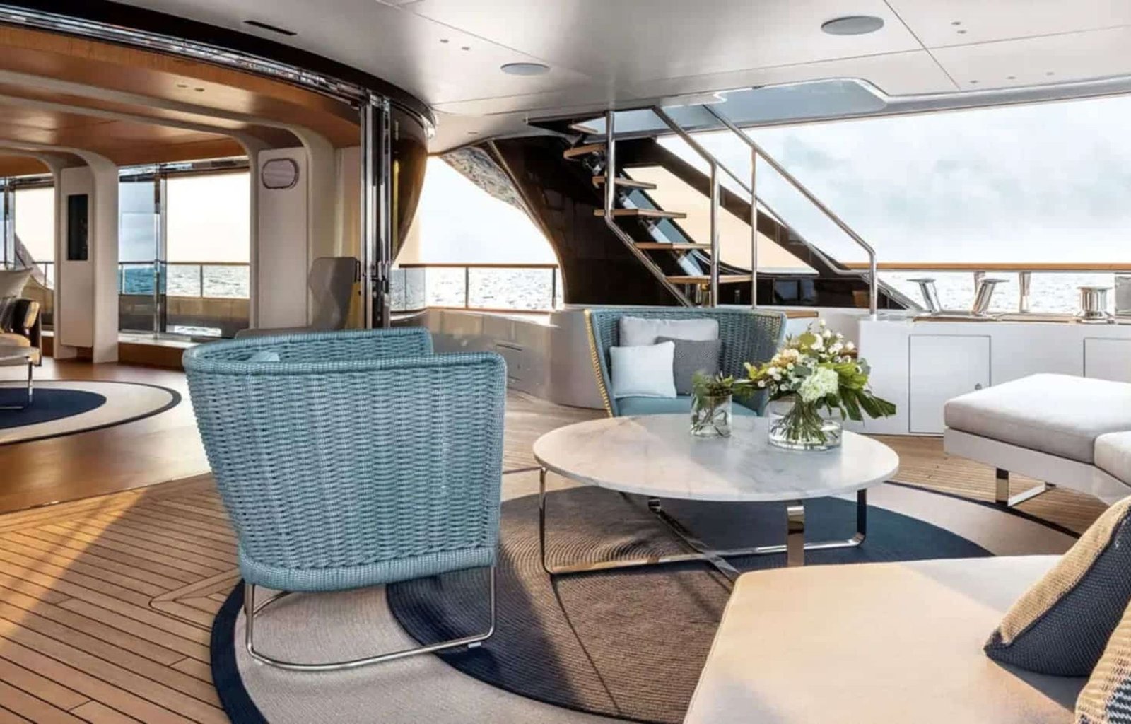 Elegant outdoor lounge space on the 125' Benetti yacht, ideal for enjoying the ocean breeze.