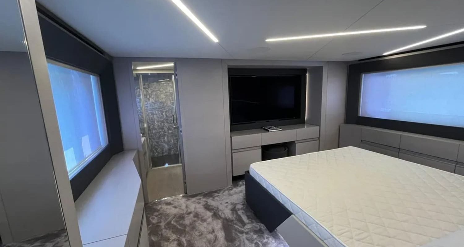 Luxurious cabin interior of the 72' Pershing yacht, featuring a spacious bed for comfort and relaxation.