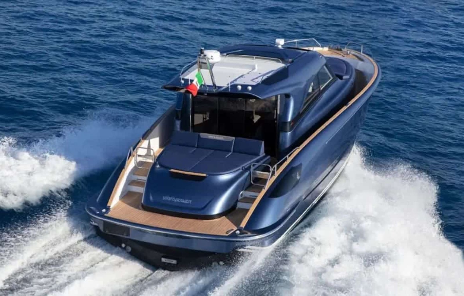 Rear angle of the yacht, emphasizing its spacious outdoor areas and luxurious features.