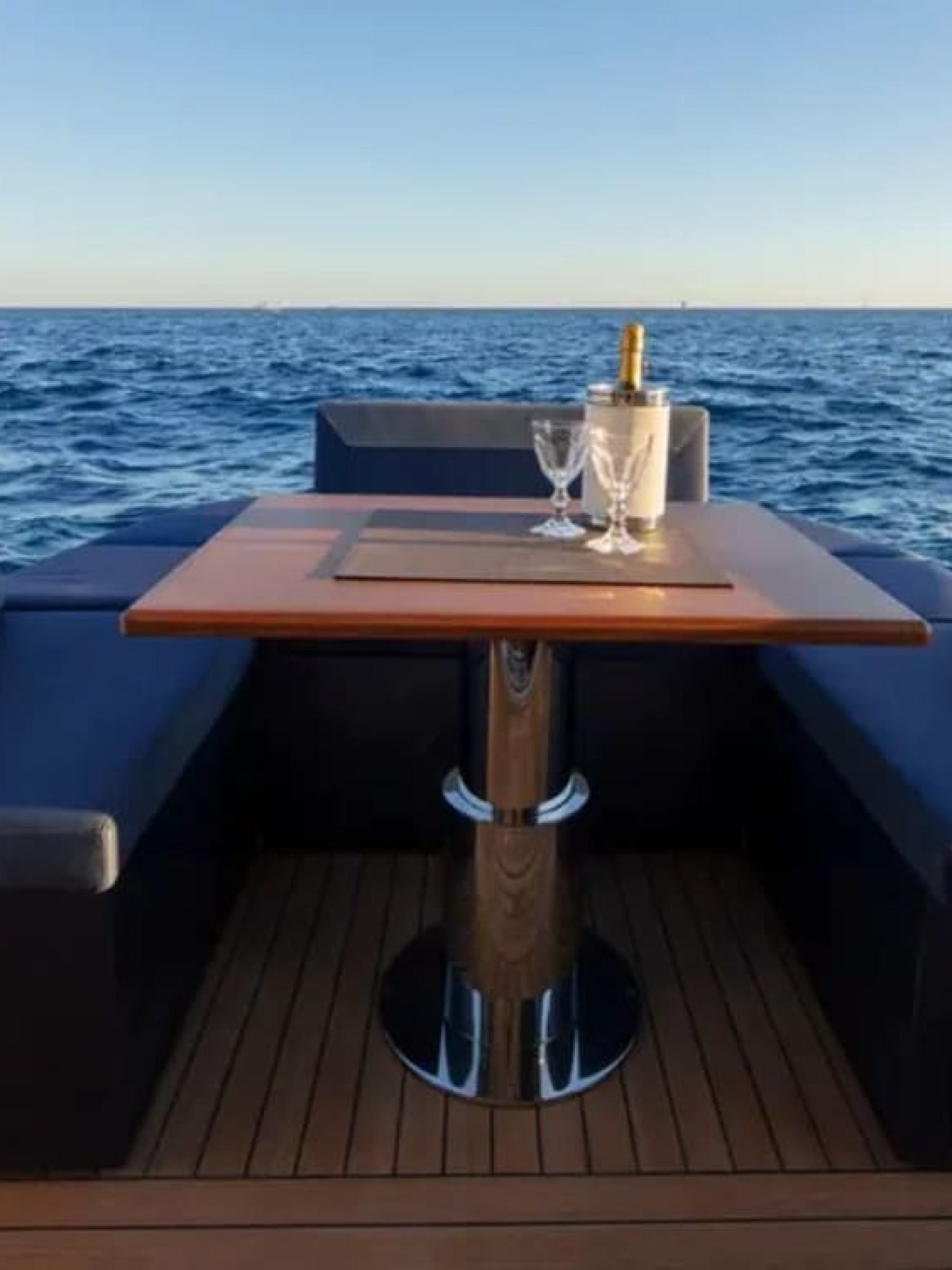 Cozy and elegant outdoor dining setup on the 48' Solaris yacht's aft deck.