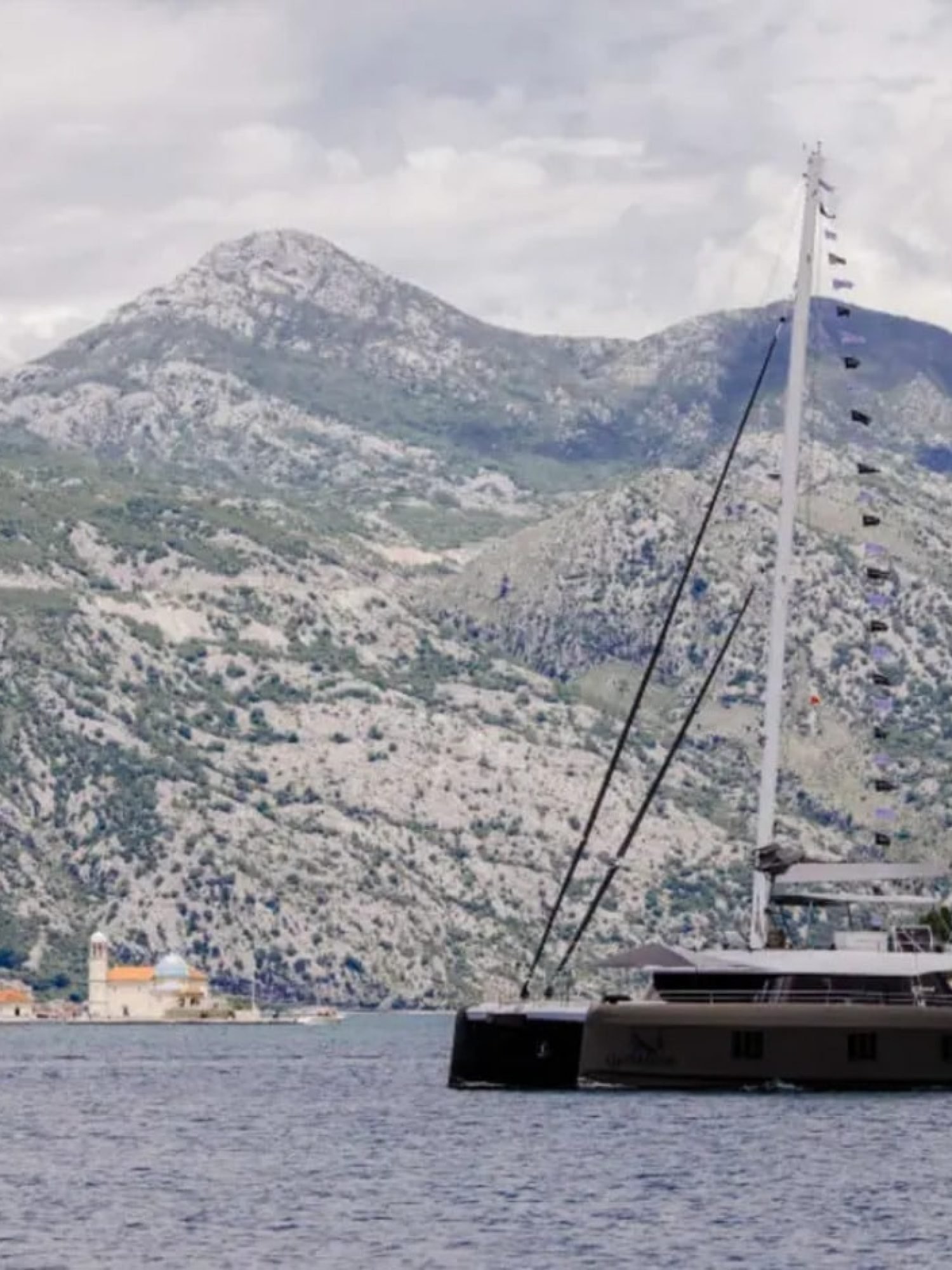 A luxurious Sunreef 60 yacht sailing at sunset, showcasing elegance and sophistication.