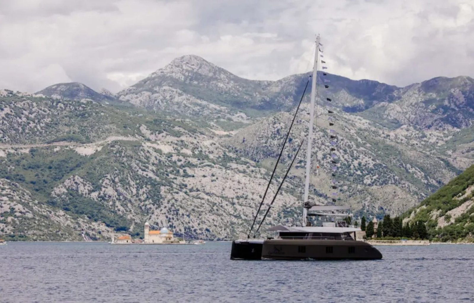 A luxurious Sunreef 60 yacht sailing at sunset, showcasing elegance and sophistication.