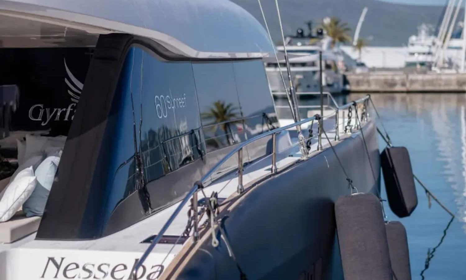 Croatia 12 A luxurious Sunreef 60 yacht anchored in crystal-clear waters, displaying its sleek design.