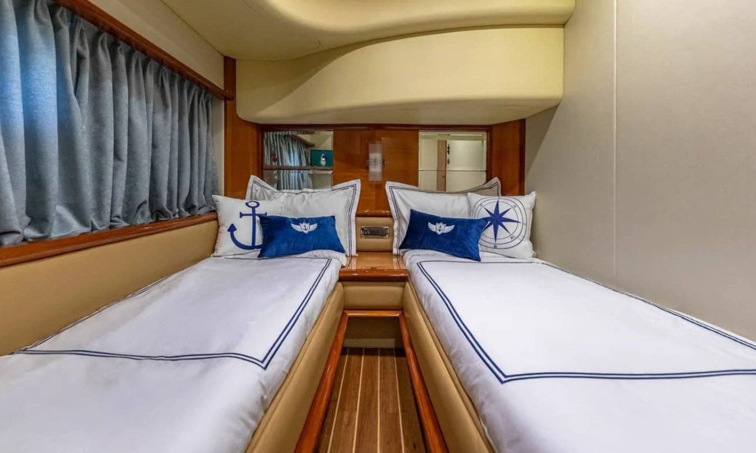 Guest cabin of the 62' AZIMUT REGAL yacht with twin beds, offering comfort and luxury for guests