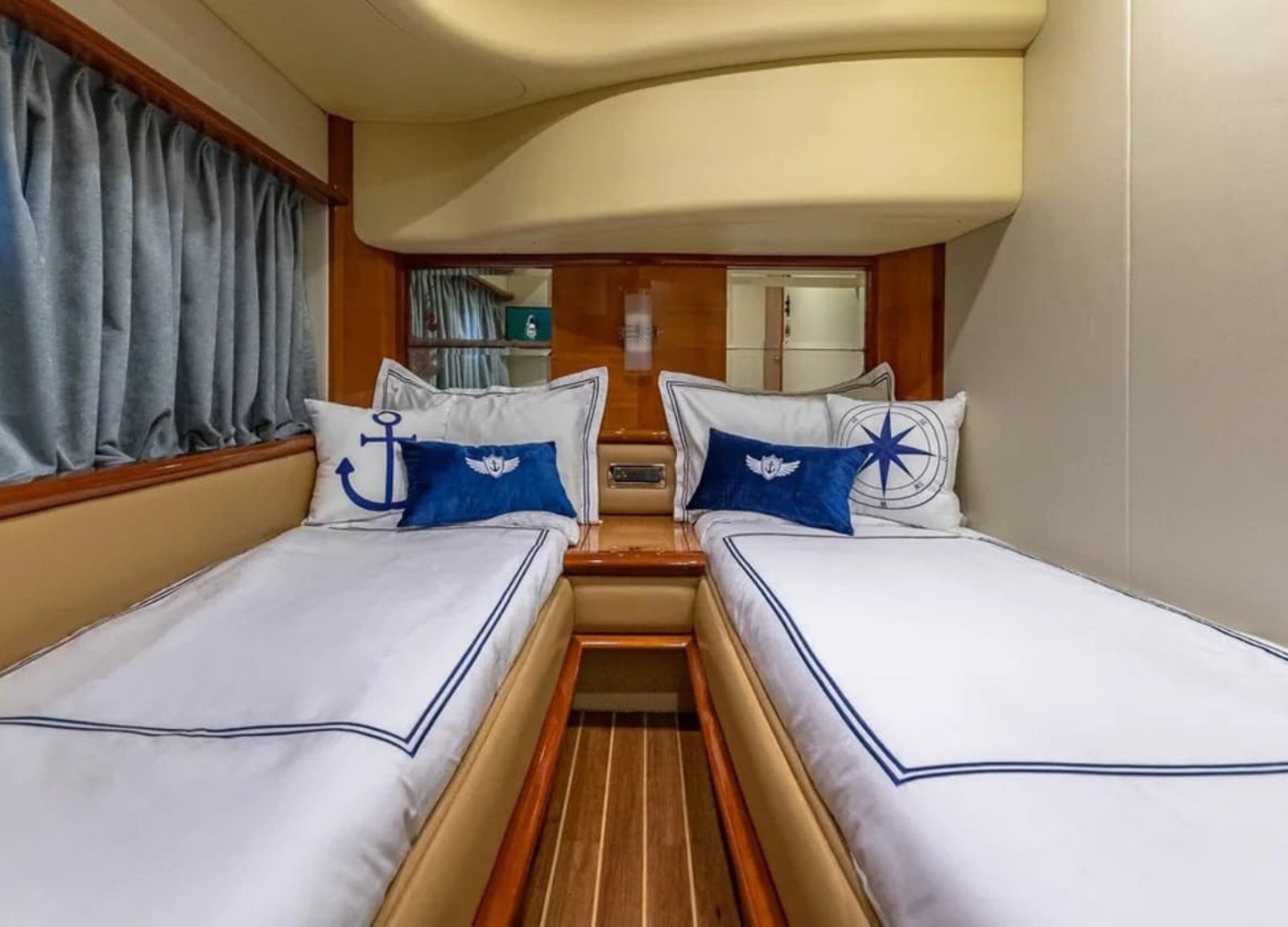 Guest cabin of the 62' AZIMUT REGAL yacht with twin beds, offering comfort and luxury for guests