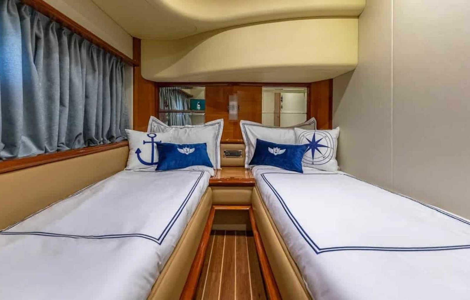 Guest cabin of the 62' AZIMUT REGAL yacht with twin beds, offering comfort and luxury for guests