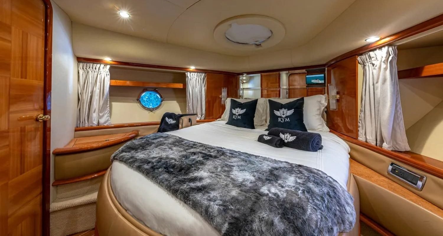 Master bedroom in the 62' AZIMUT REGAL yacht, offering a spacious and luxurious retreat.