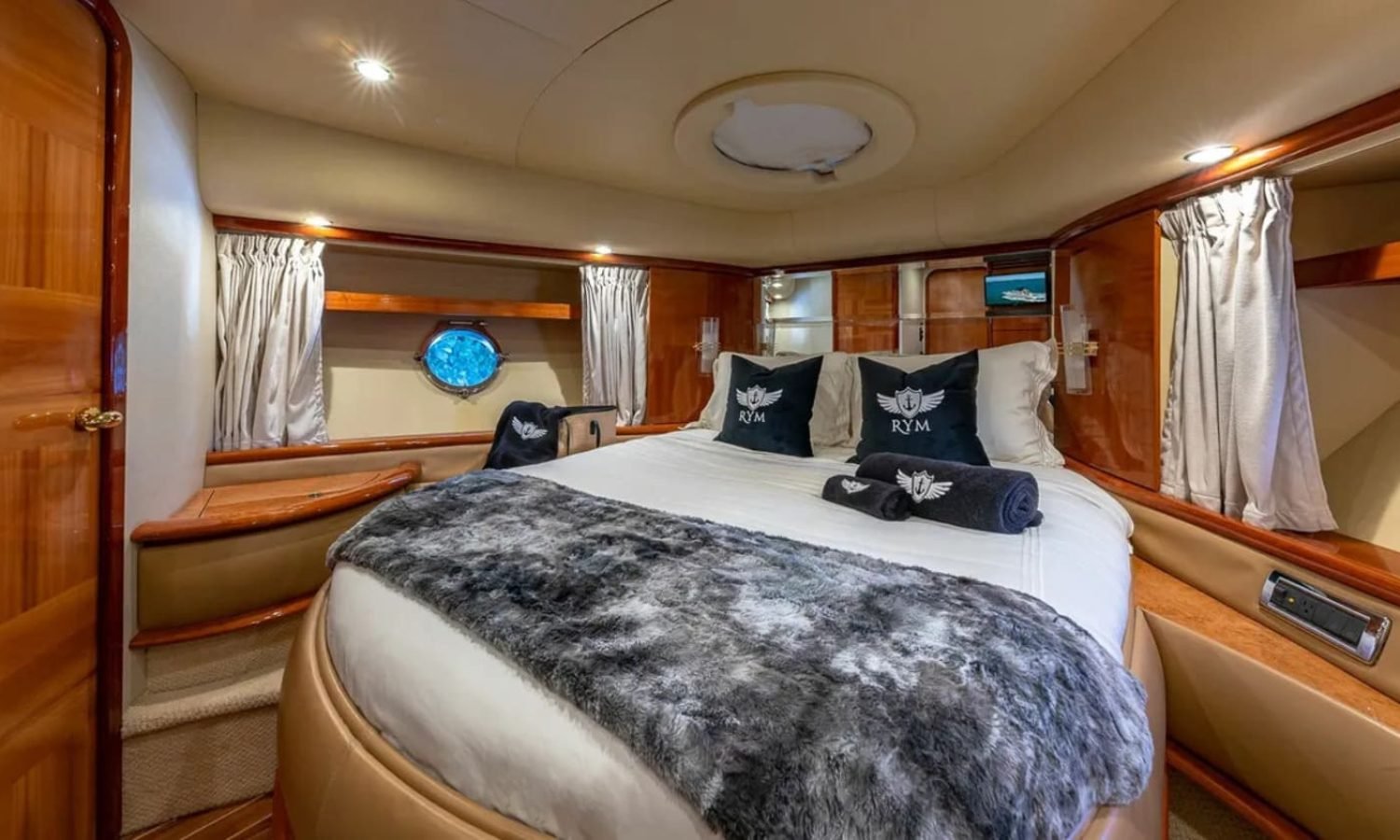 Master bedroom in the 62' AZIMUT REGAL yacht, offering a spacious and luxurious retreat.