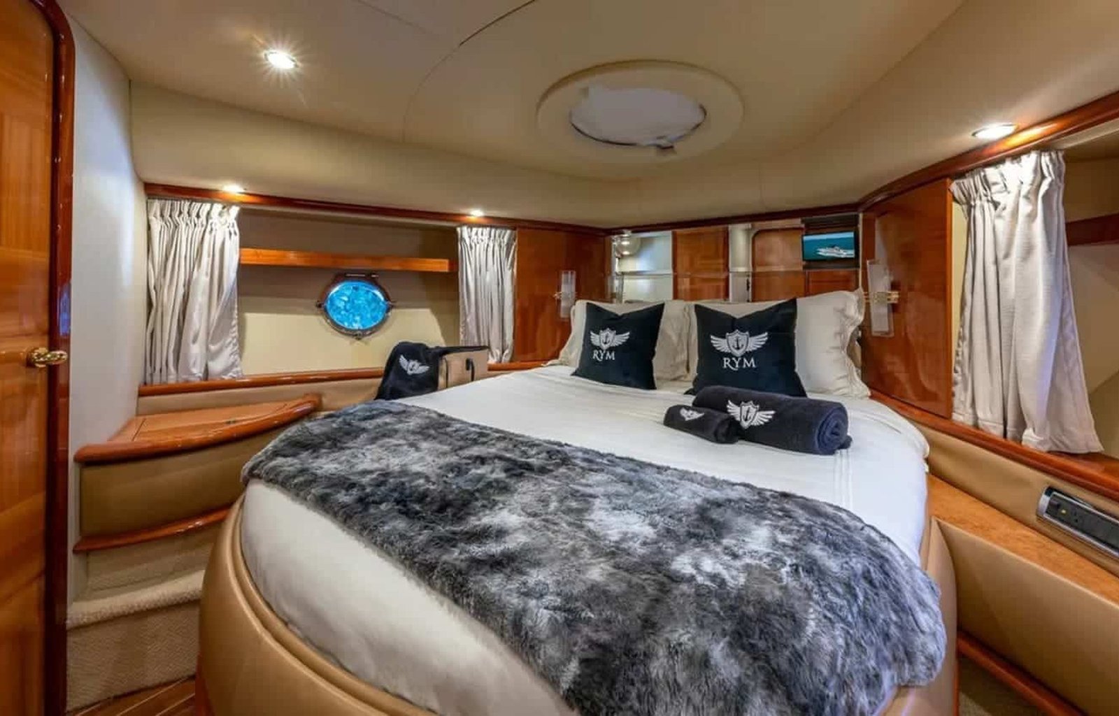 Master bedroom in the 62' AZIMUT REGAL yacht, offering a spacious and luxurious retreat.