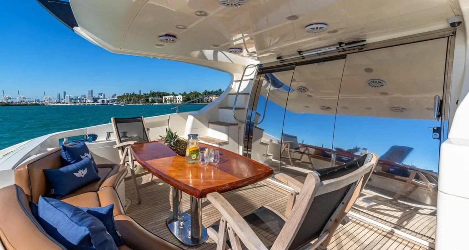 Outdoor dining area on the 62' AZIMUT REGAL yacht, perfect for enjoying meals and the sea breeze.