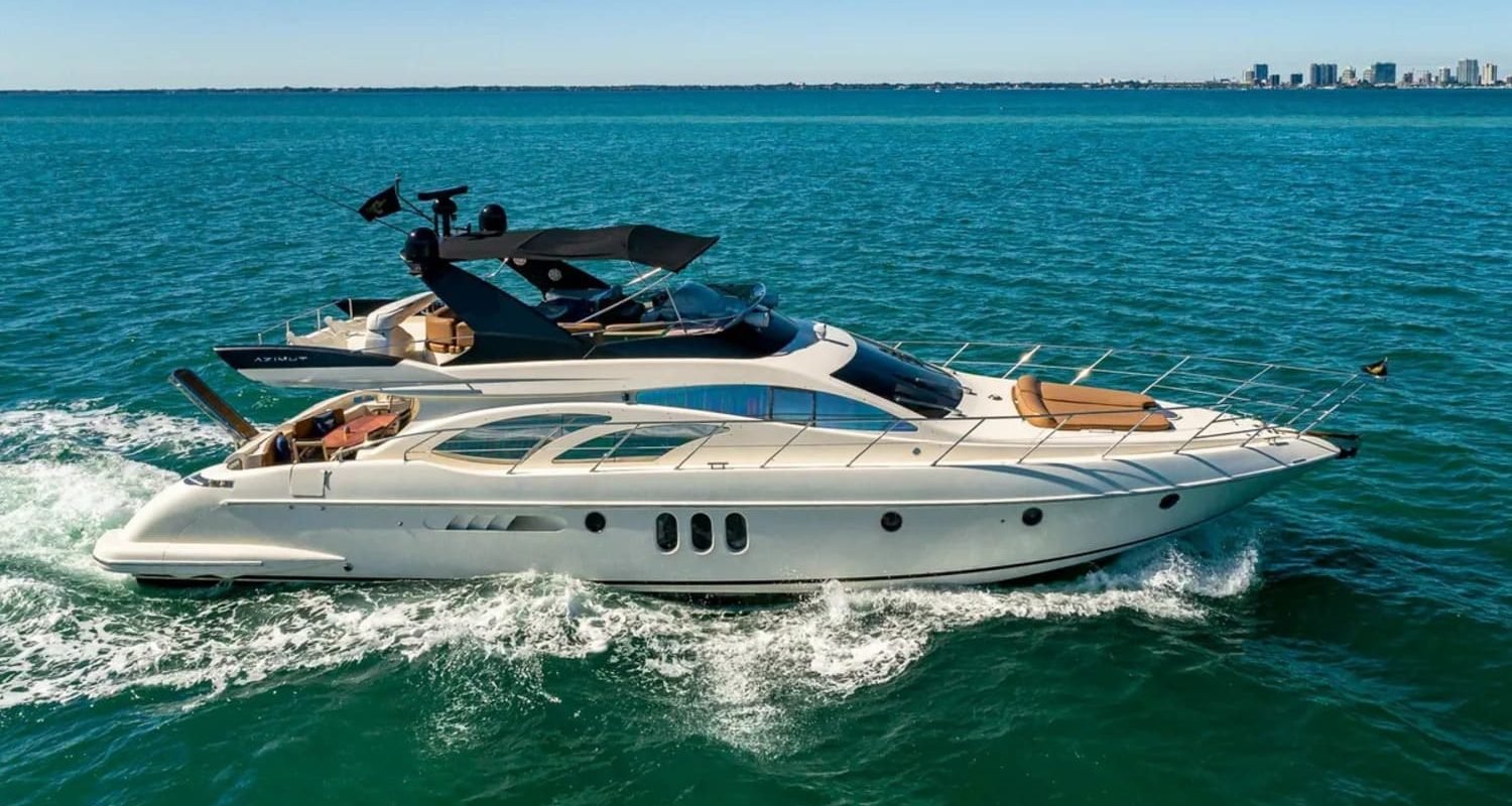 62' AZIMUT REGAL yacht sailing on the water, showcasing its elegant design and superior performance in a luxurious setting.