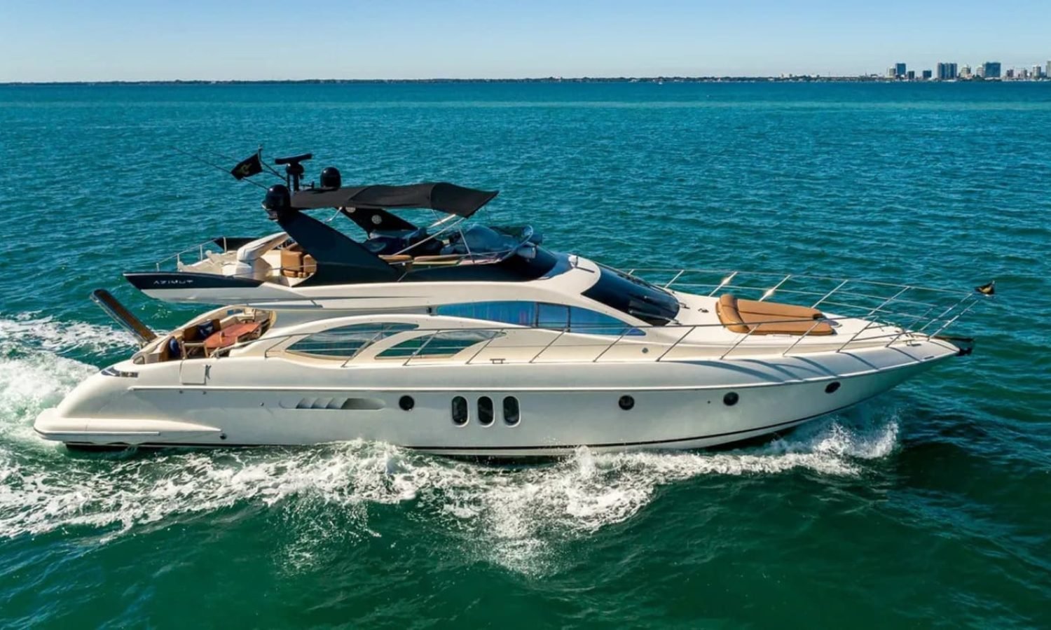 62' AZIMUT REGAL yacht sailing on the water, showcasing its elegant design and superior performance in a luxurious setting.