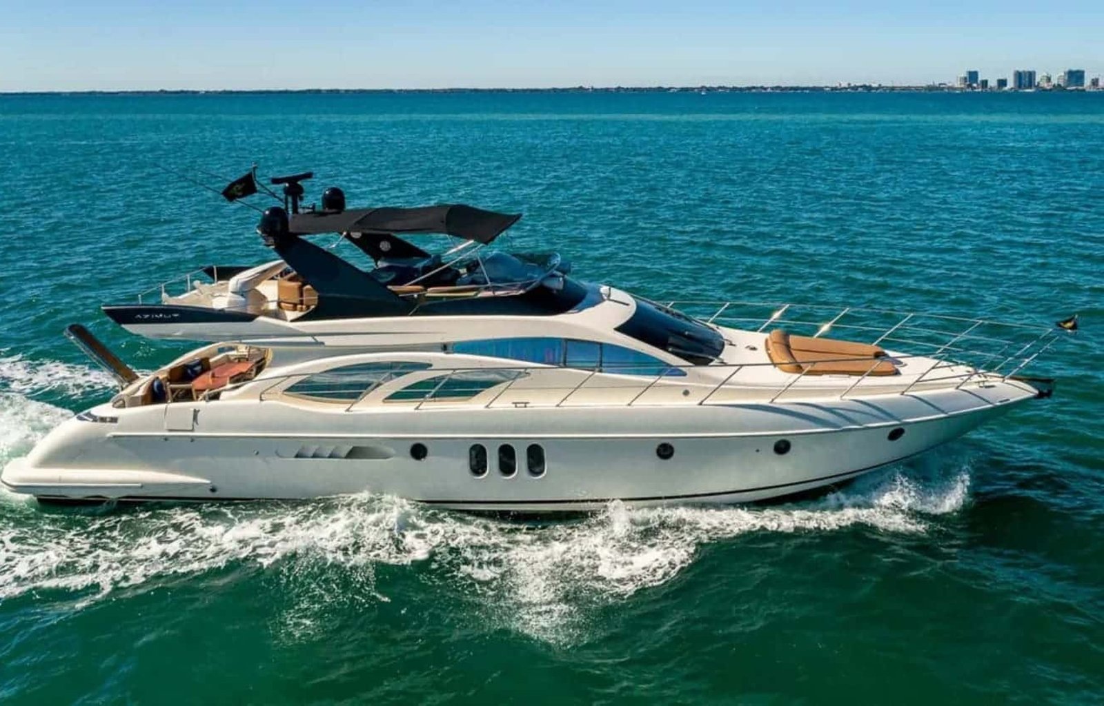62' AZIMUT REGAL yacht sailing on the water, showcasing its elegant design and superior performance in a luxurious setting.