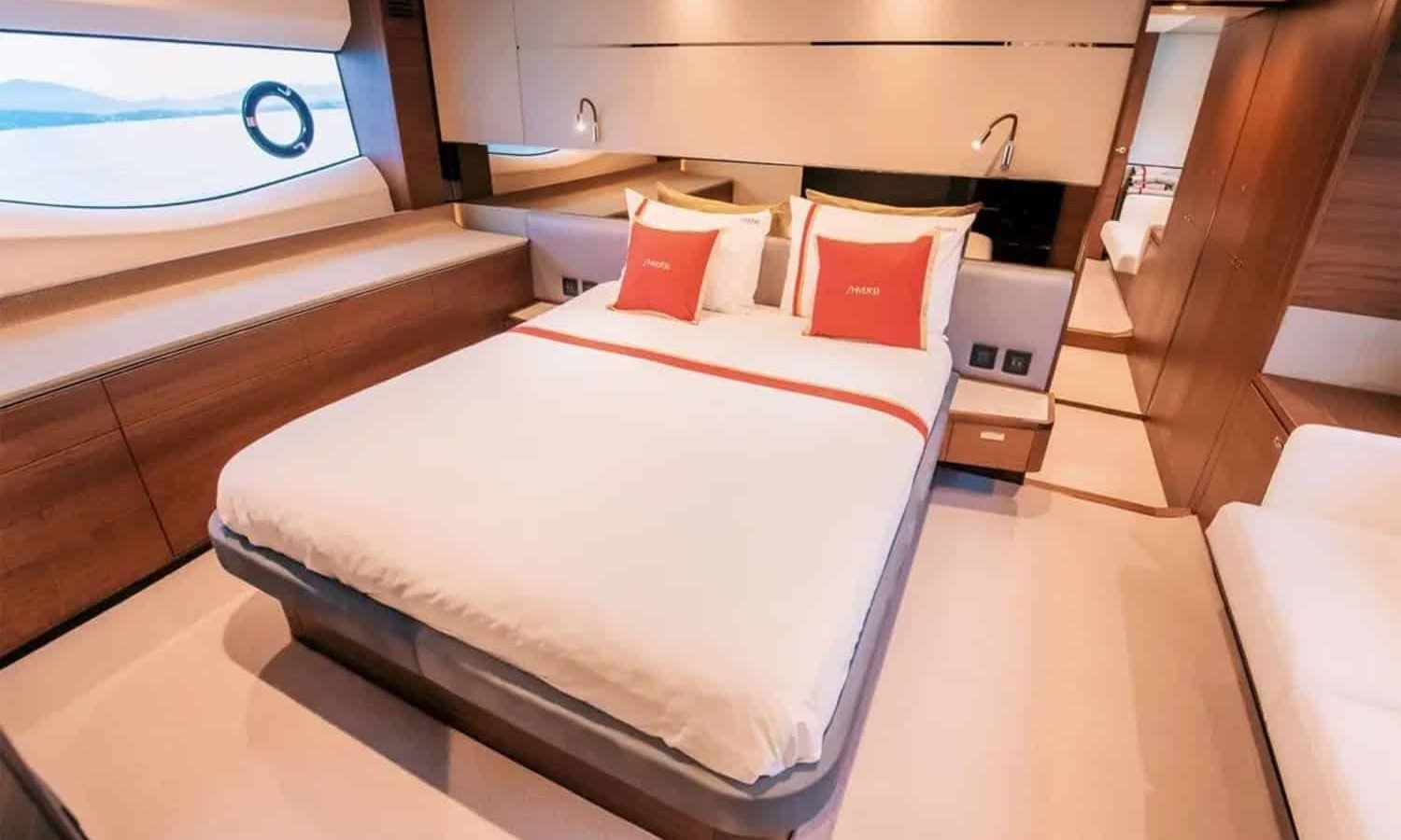 Elegant VIP cabin featuring a plush double bed, refined décor, and ample storage space.