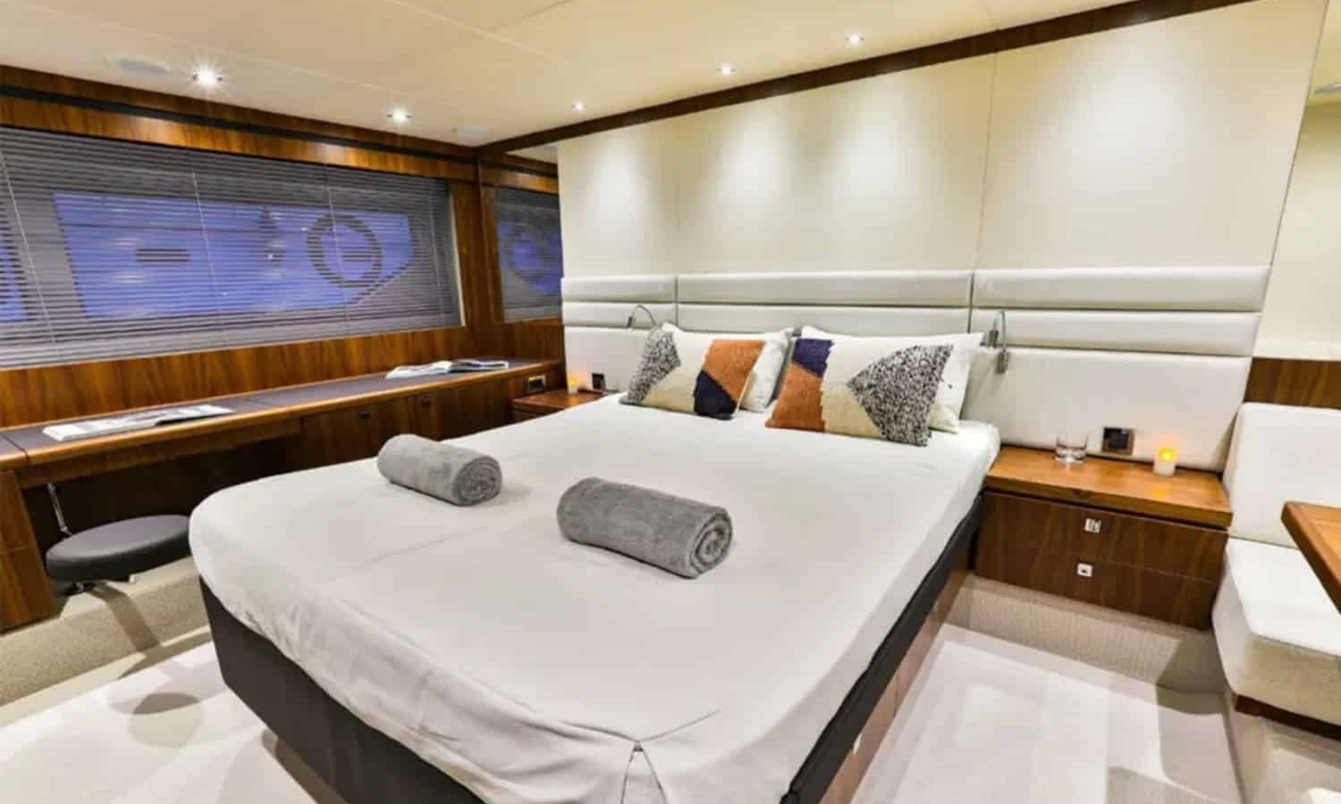 Spacious master bedroom with a comfortable bed inside the yacht