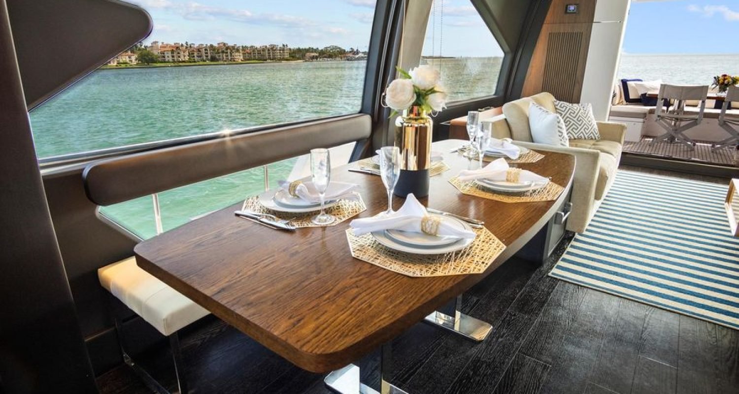 Interior dining area of the 72' Azimut Flybridge, featuring an elegant table setup with seating for guests, designed for refined onboard dining.