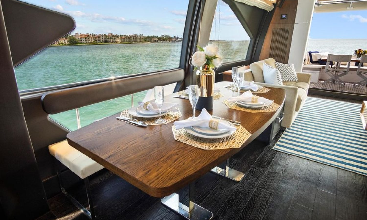 Interior dining area of the 72' Azimut Flybridge, featuring an elegant table setup with seating for guests, designed for refined onboard dining.