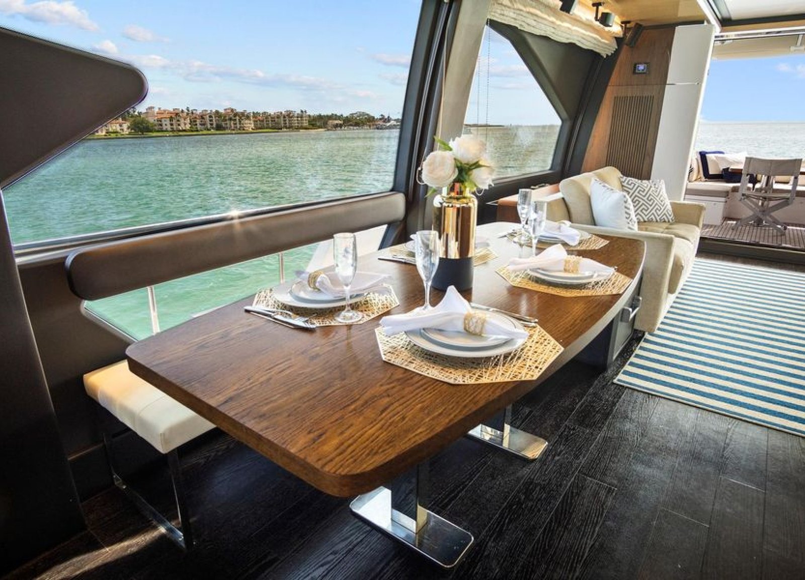 Interior dining area of the 72' Azimut Flybridge, featuring an elegant table setup with seating for guests, designed for refined onboard dining.