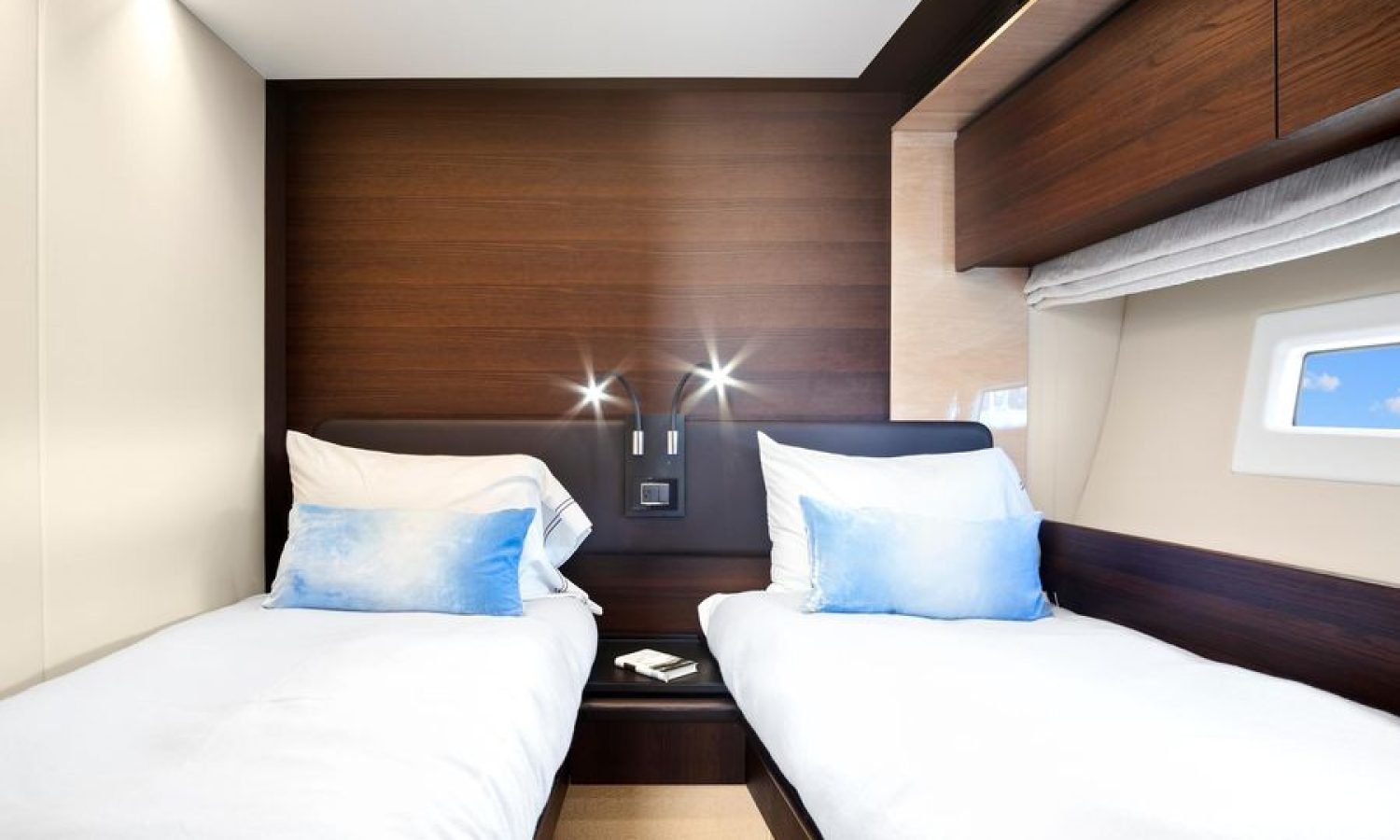 Interior view of the twin-bed cabin inside the 72' Azimut Flybridge yacht, featuring two comfortable beds, soft ambient lighting, and modern decor for a relaxing stay.