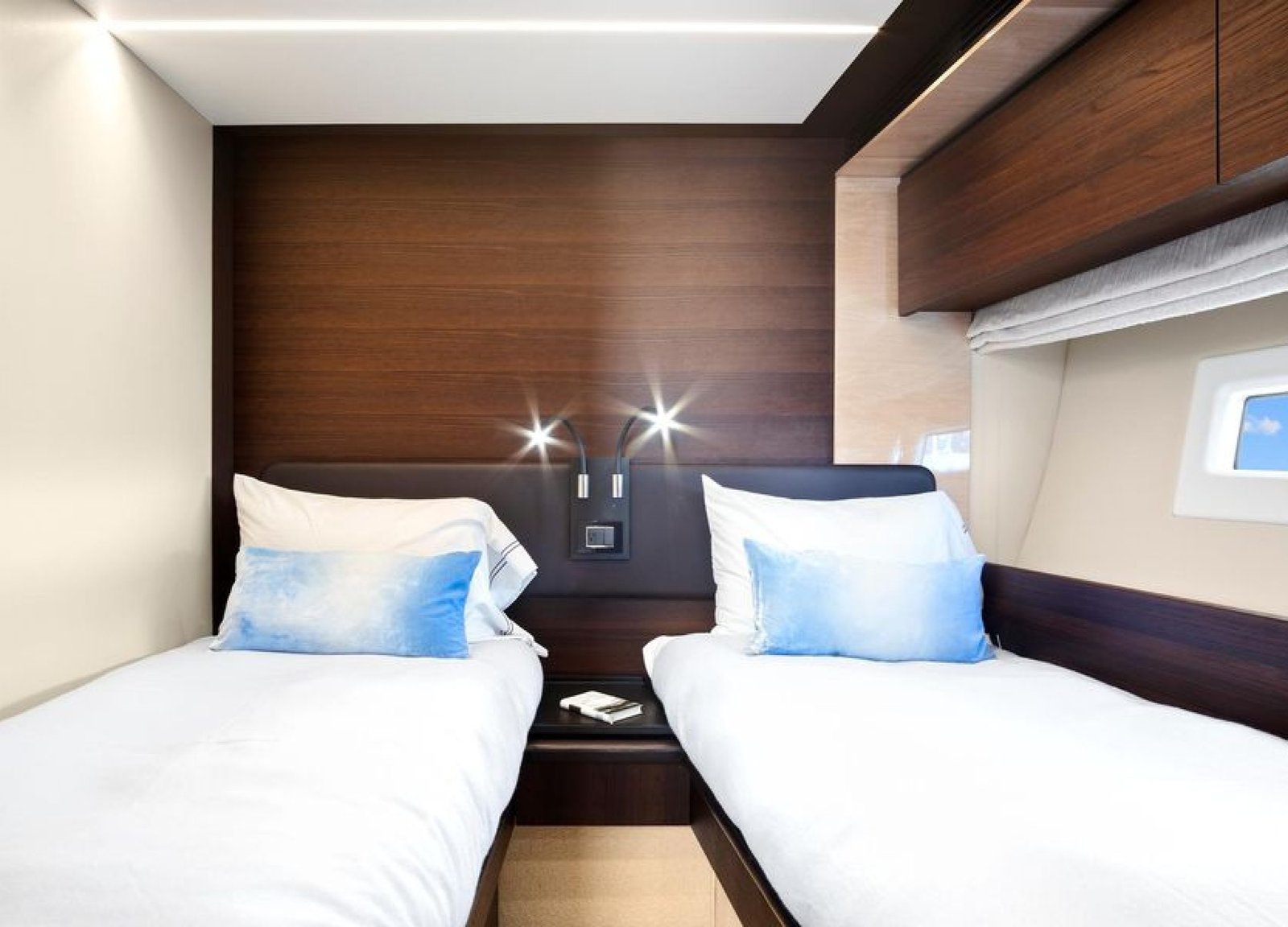 Interior view of the twin-bed cabin inside the 72' Azimut Flybridge yacht, featuring two comfortable beds, soft ambient lighting, and modern decor for a relaxing stay.