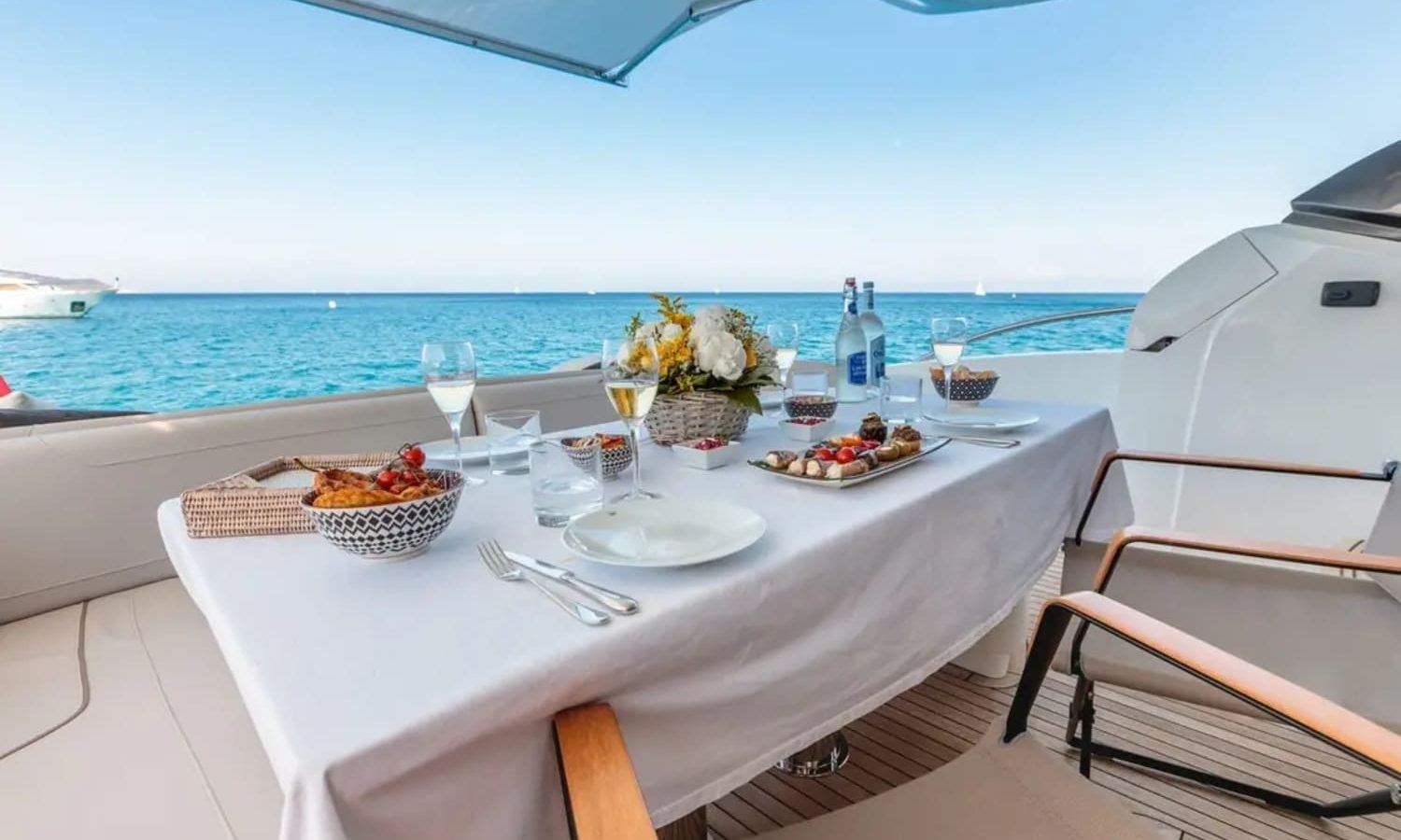 Luxurious outdoor dining setup on the aft deck of the 74' Princess Flybridge.