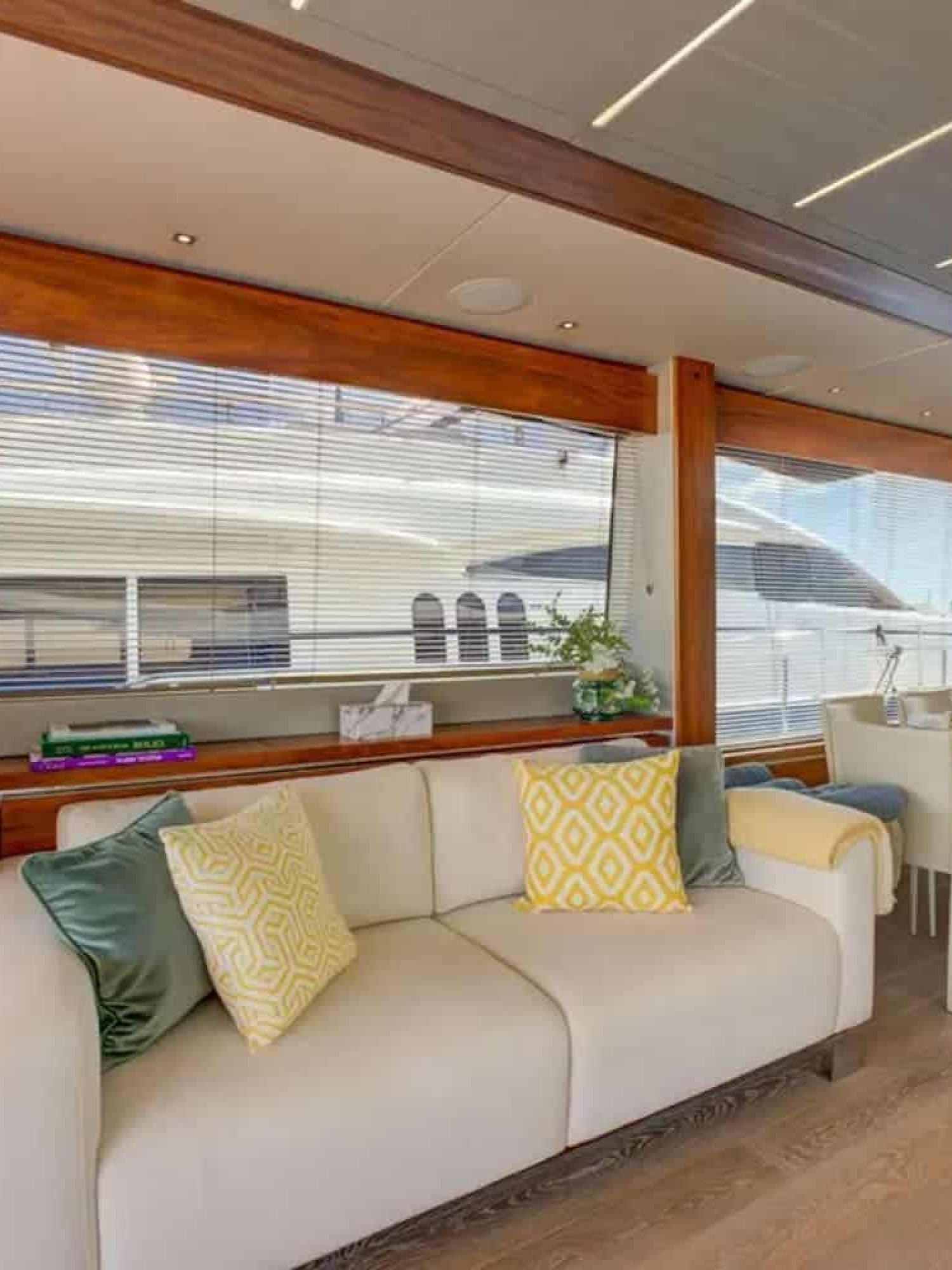 Spacious salon with panoramic windows and luxurious furnishings aboard the 78' Sunseeker.