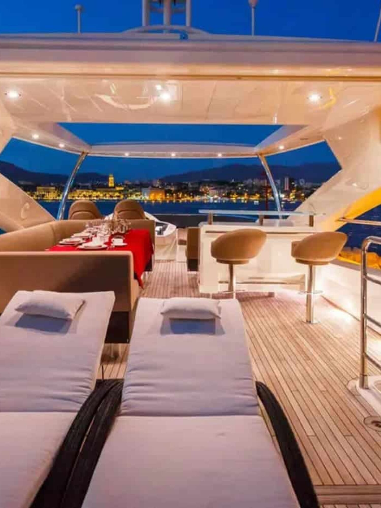 Luxurious upper deck lounge area of the yacht, offering panoramic ocean views.