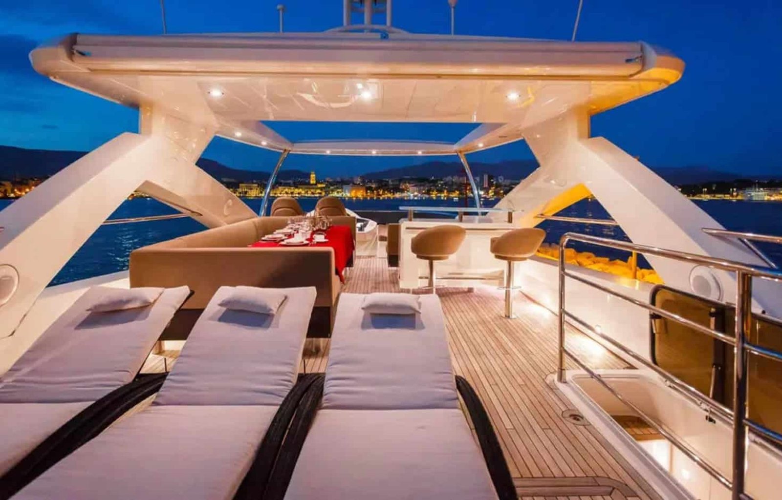 Luxurious upper deck lounge area of the yacht, offering panoramic ocean views.