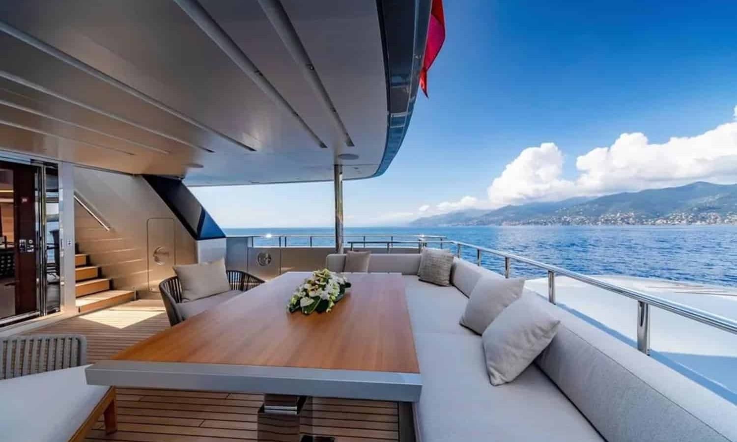 Outdoor seating area aboard the yacht with panoramic views.