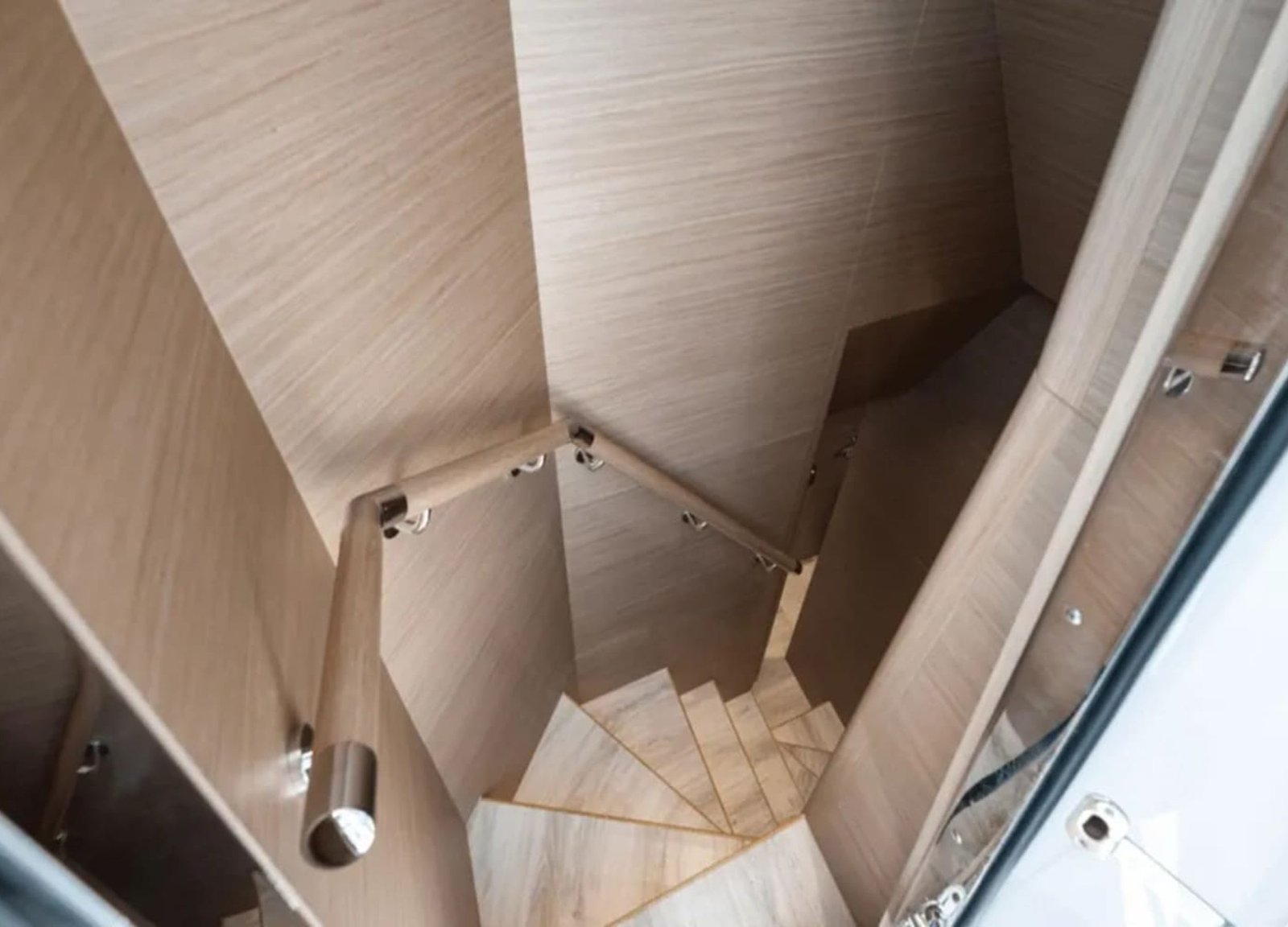 Elegant staircase leading to the lower deck of the 90' HORIZON yacht