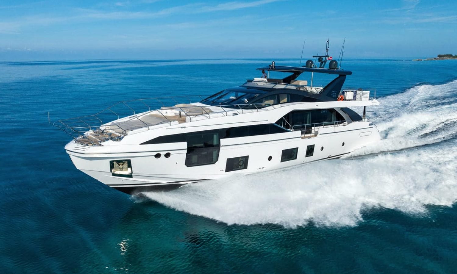 Side view of the 88' AZIMUT yacht cutting through the waves, demonstrating its elegant craftsmanship and powerful performance.