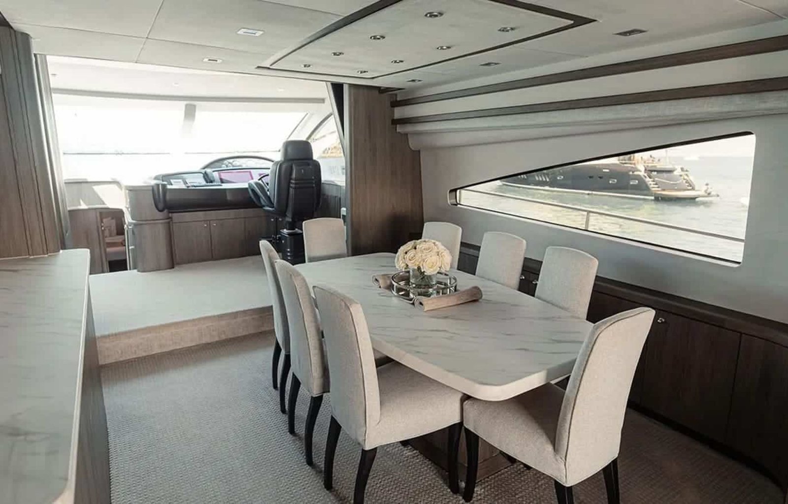 Stylish indoor dining area of the 82' Sunseeker yacht with a modern table setup.