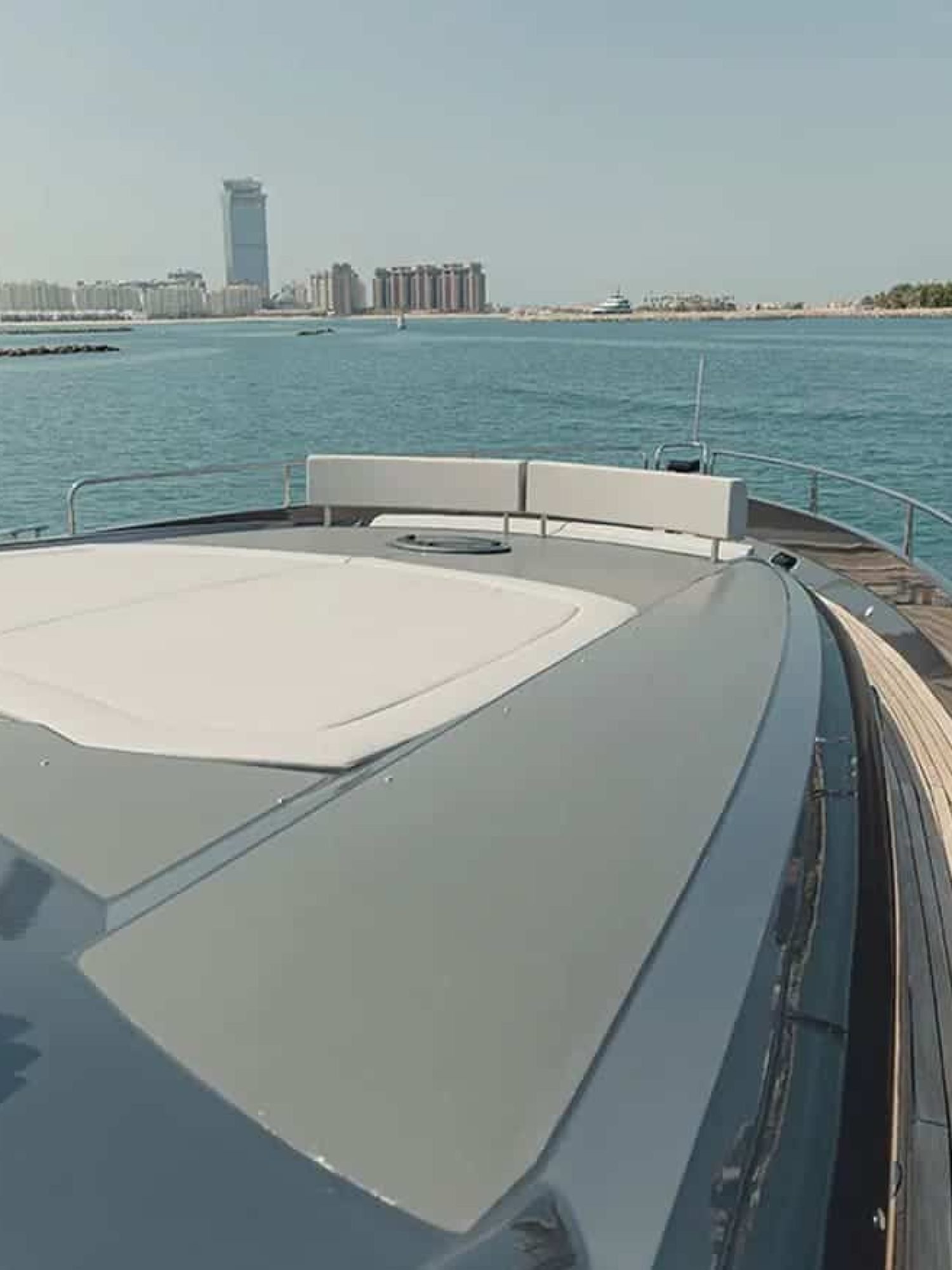 Front view of the 82' Sunseeker yacht, displaying its aerodynamic shape and sun pad area.