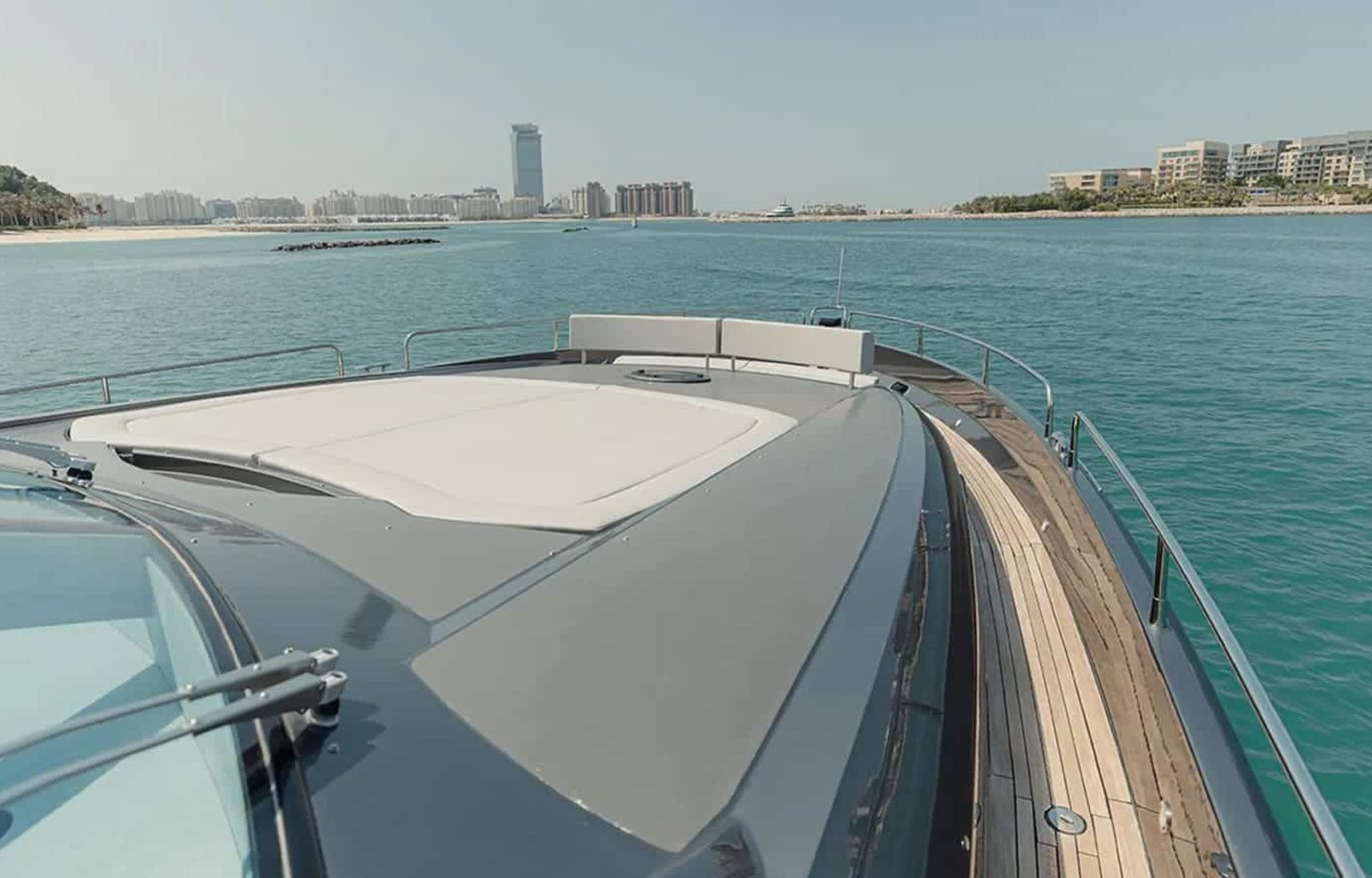 Front view of the 82' Sunseeker yacht, displaying its aerodynamic shape and sun pad area.