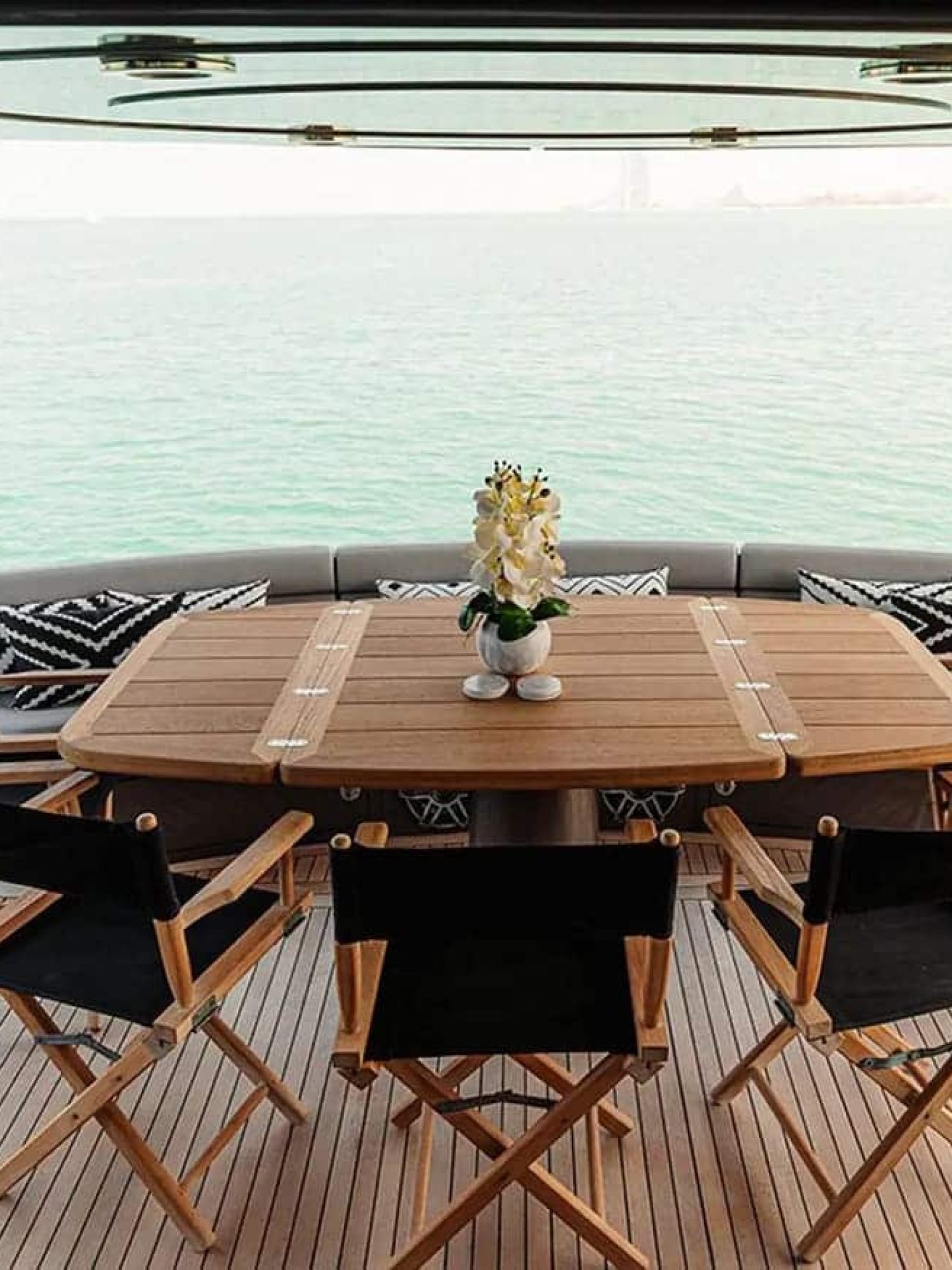 Elegant outdoor dining setup on the aft deck of the 82' Sunseeker yacht with stunning sea views.