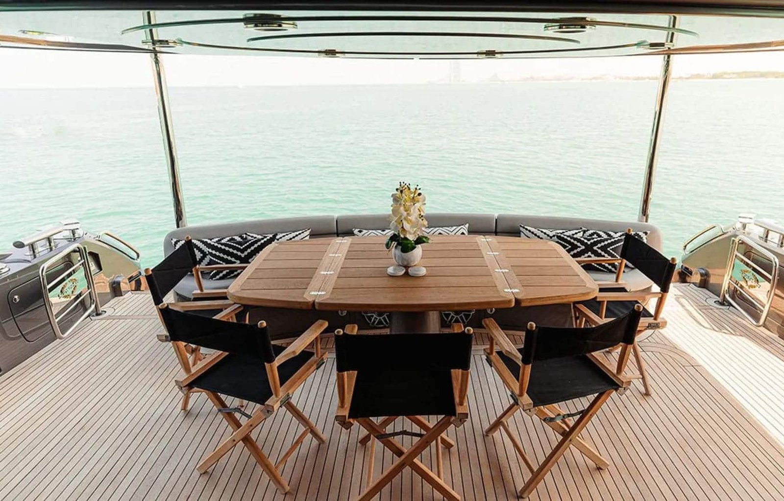 Elegant outdoor dining setup on the aft deck of the 82' Sunseeker yacht with stunning sea views.