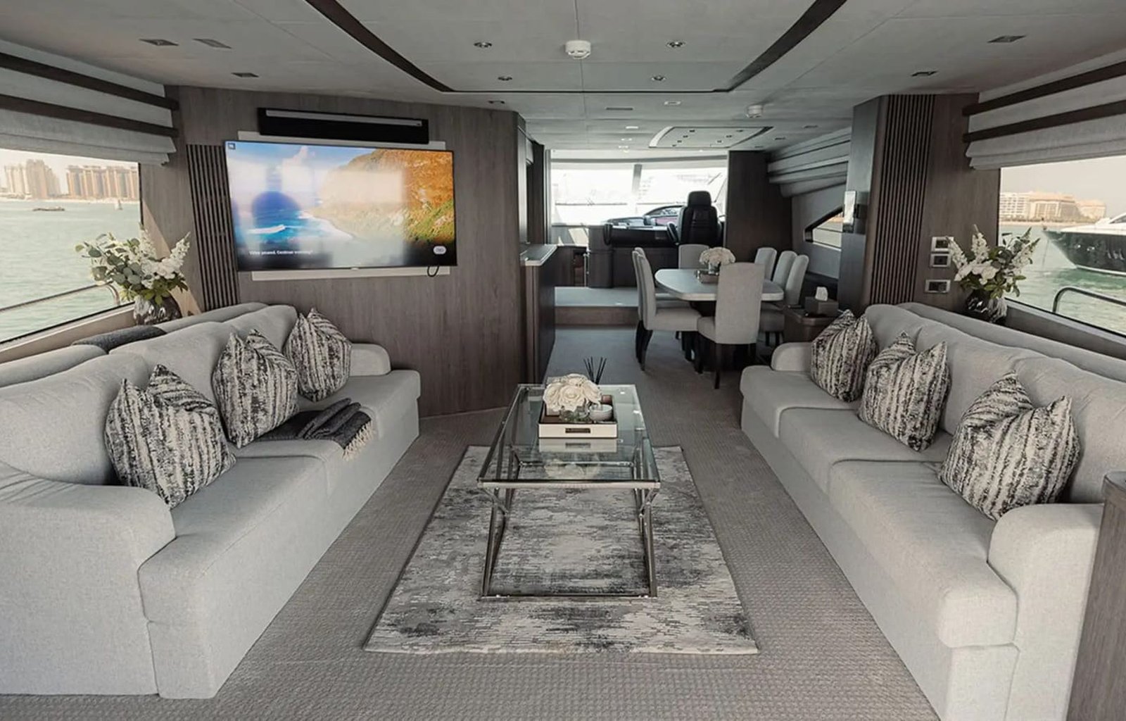 Cozy lounge inside the 82' Sunseeker yacht, featuring plush sofas and ambient lighting.