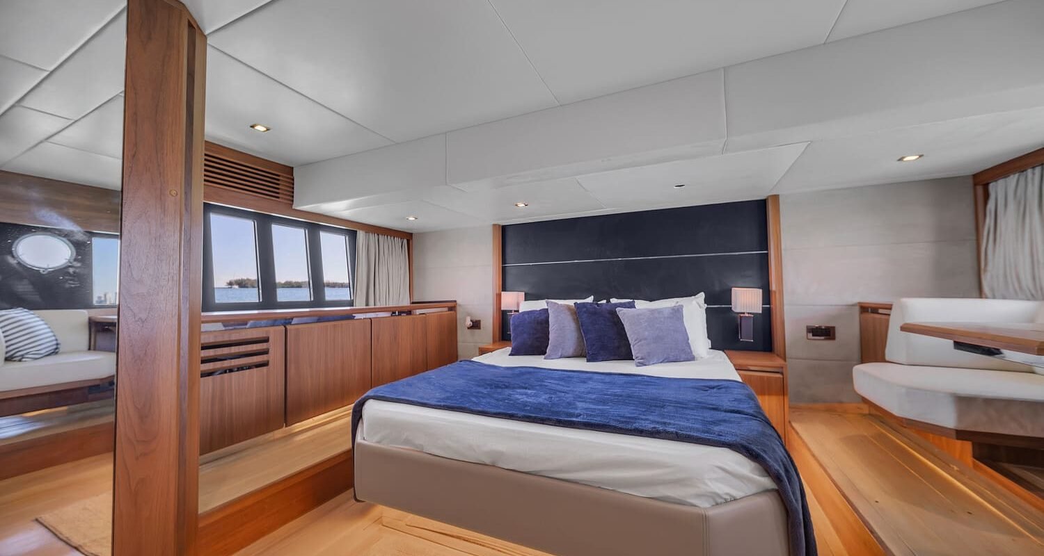 Interior view of the 60' ABSOLUTE FLY yacht master bedroom featuring a large, comfortable bed.