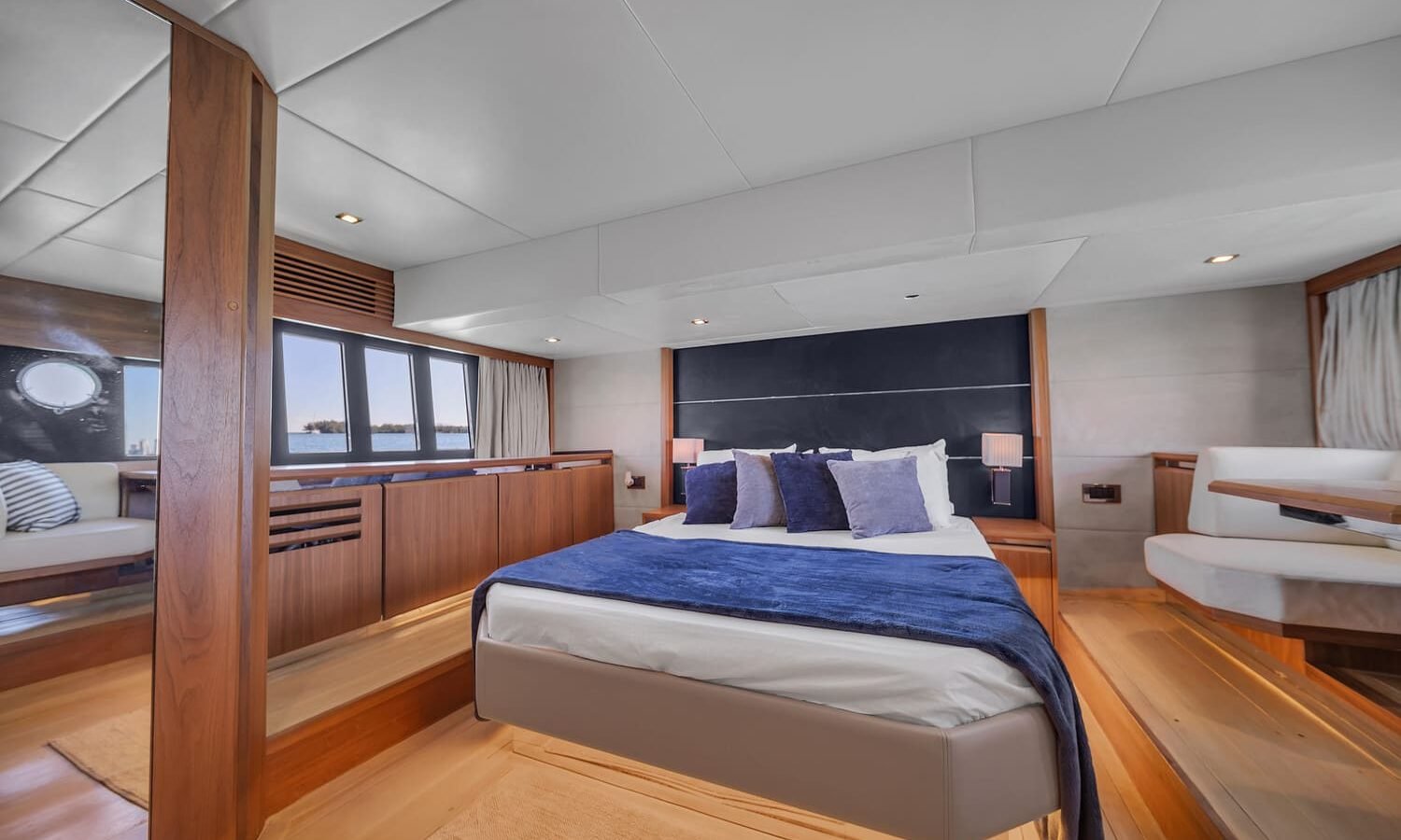 Interior view of the 60' ABSOLUTE FLY yacht master bedroom featuring a large, comfortable bed.