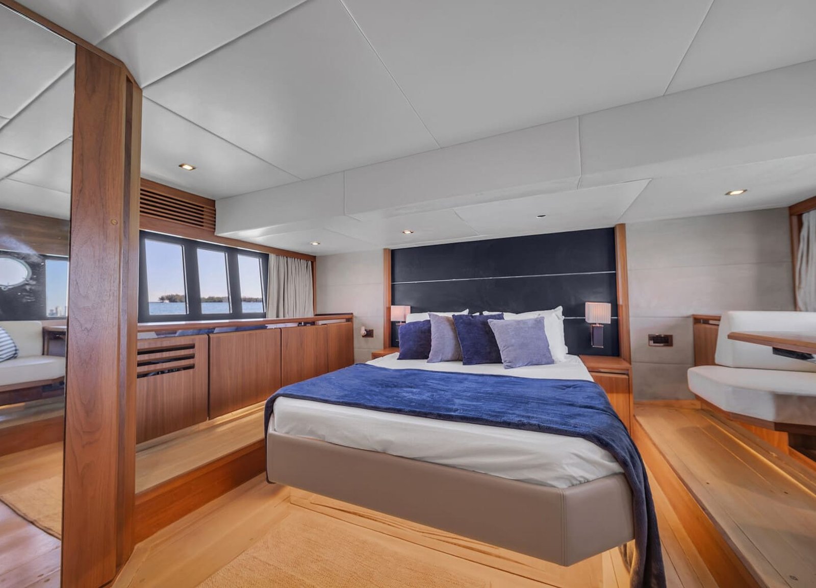 Interior view of the 60' ABSOLUTE FLY yacht master bedroom featuring a large, comfortable bed.