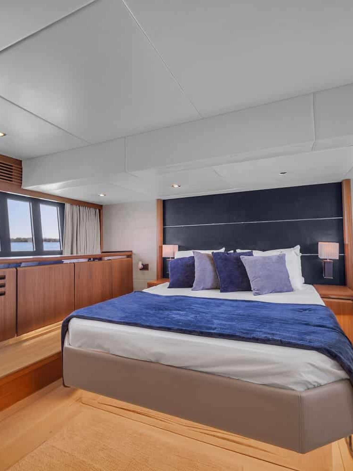 Interior view of the 60' ABSOLUTE FLY yacht master bedroom featuring a large, comfortable bed.