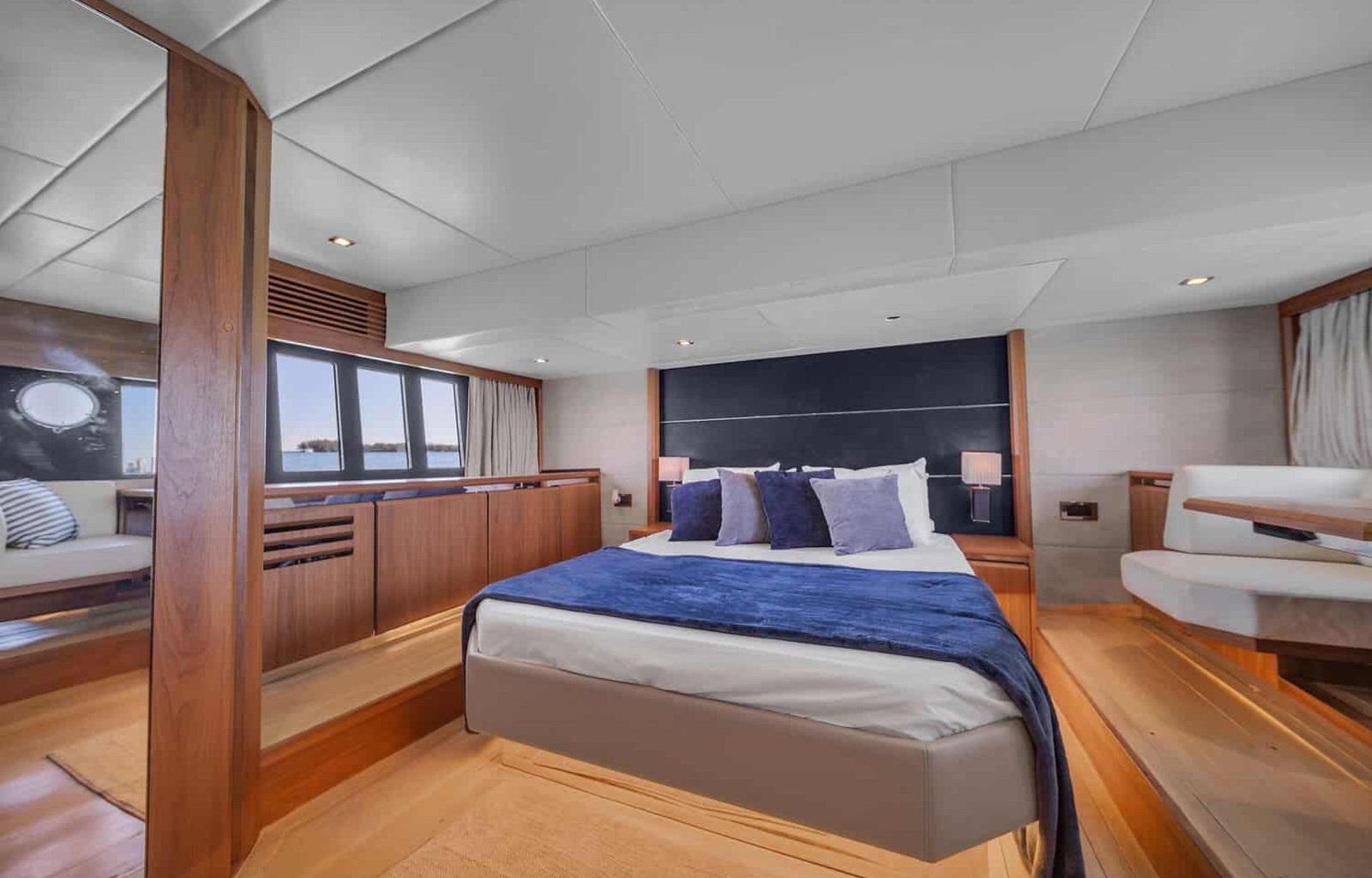 Interior view of the 60' ABSOLUTE FLY yacht master bedroom featuring a large, comfortable bed.