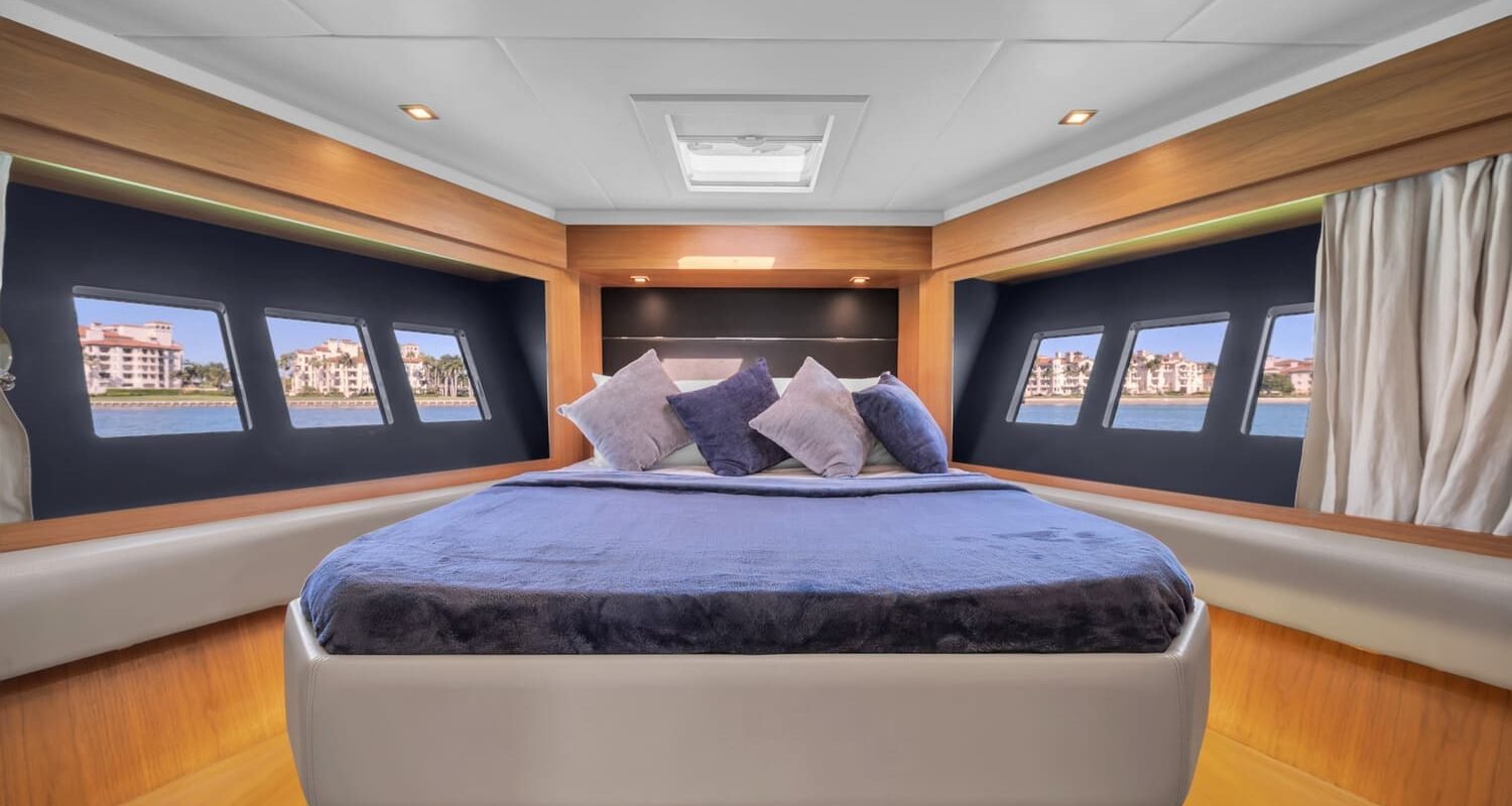 The luxurious master bedroom of the 60' ABSOLUTE FLY yacht, featuring a king-sized bed.