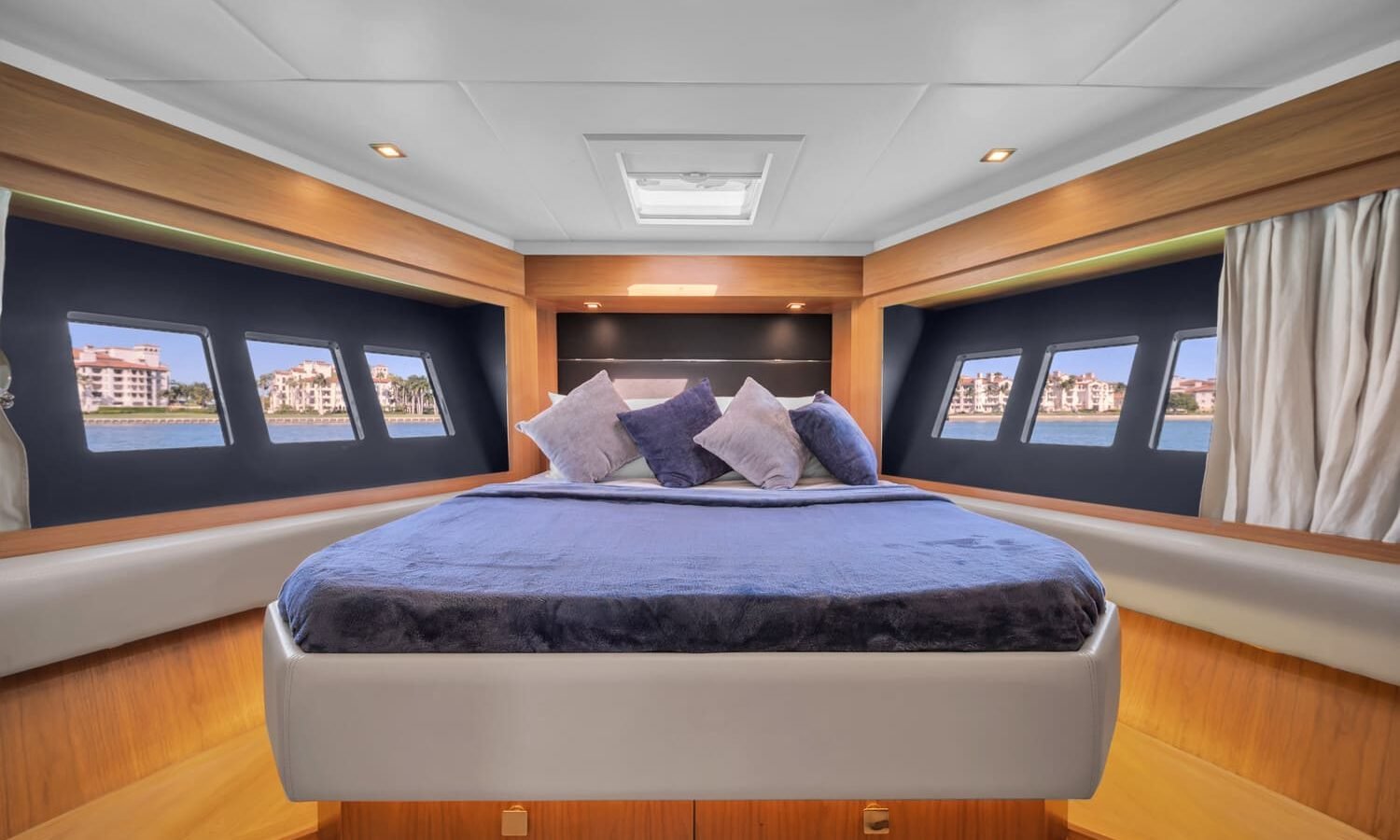 The luxurious master bedroom of the 60' ABSOLUTE FLY yacht, featuring a king-sized bed.