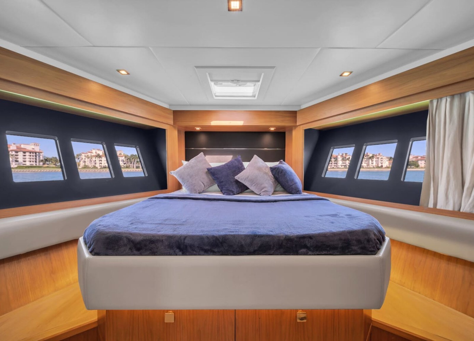 The luxurious master bedroom of the 60' ABSOLUTE FLY yacht, featuring a king-sized bed.