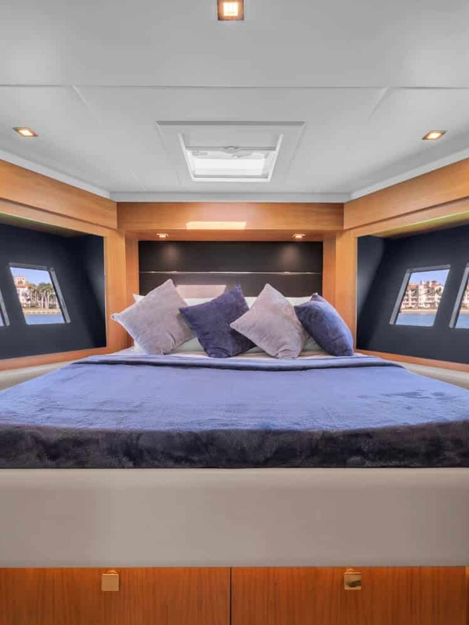 The luxurious master bedroom of the 60' ABSOLUTE FLY yacht, featuring a king-sized bed.