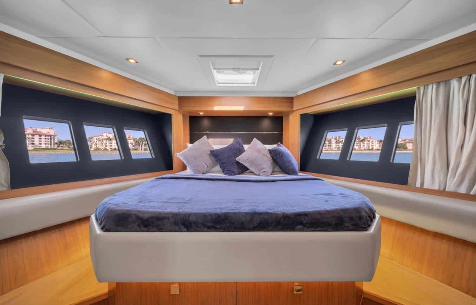 The luxurious master bedroom of the 60' ABSOLUTE FLY yacht, featuring a king-sized bed.